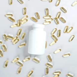 A white supplement bottle with capsules